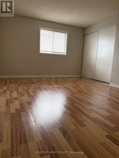 A room with wooden flooring and a window.