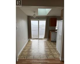 A room with a tiled floor and a window with blinds.