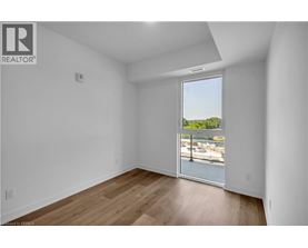 A room with a view of a marina through a sliding glass door.