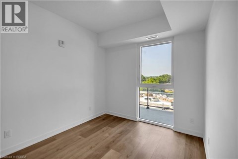 A room with a view of a marina through a sliding glass door.