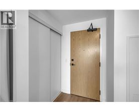 A wooden door with a black handle and a black latch.