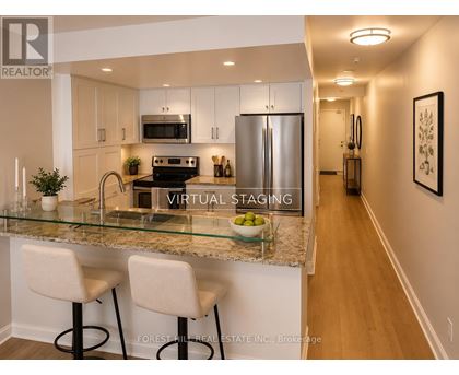 A kitchen with a glass counter top and white bar stools.