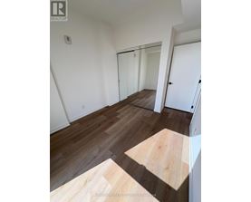 A room with wooden flooring and white walls.