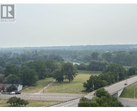 A real estate brokerage logo is superimposed on a photo of a suburban area.