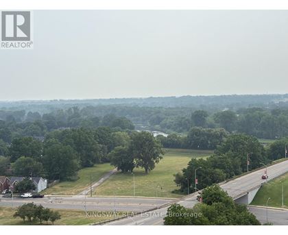 A real estate brokerage logo is superimposed on a photo of a suburban area.