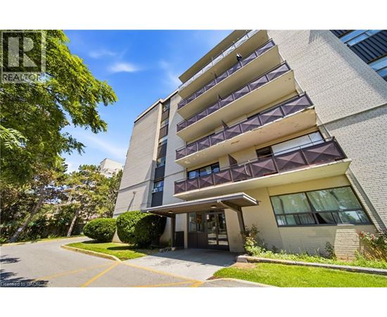A modern apartment building with a clear blue sky above.