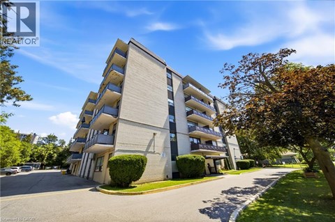 A tall apartment building with balconies on the second floor.
