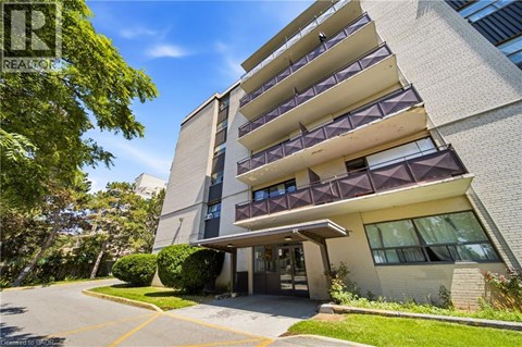 A modern apartment building with a clear blue sky above.