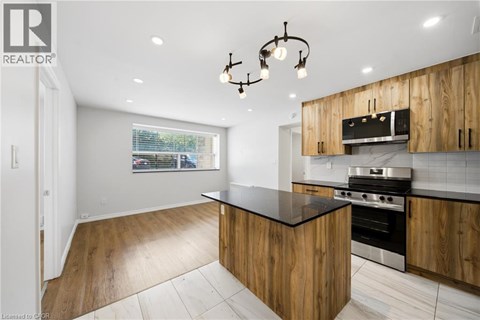 A modern kitchen with wooden cabinets and a black countertop.