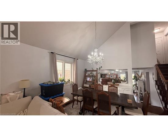 A dining room with a wooden table and chairs.
