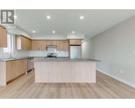A modern kitchen with wooden cabinets and a central island.