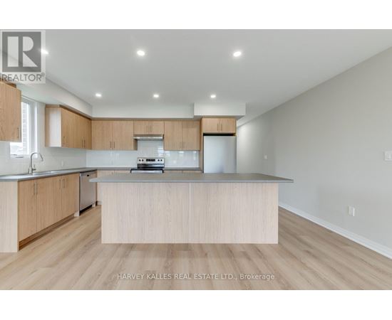 A modern kitchen with wooden cabinets and a central island.