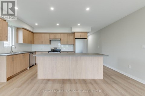 A modern kitchen with wooden cabinets and a central island.