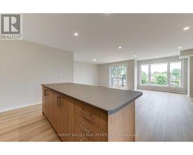 A spacious kitchen with wooden cabinets and a large island.
