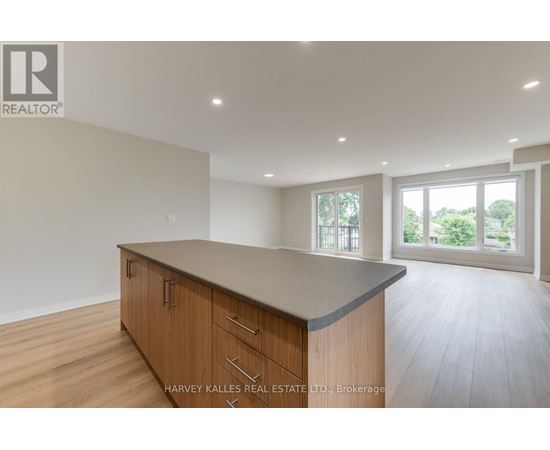 A spacious kitchen with wooden cabinets and a large island.