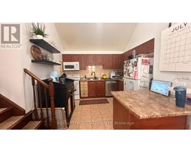 A kitchen with a counter and a calendar on the wall.