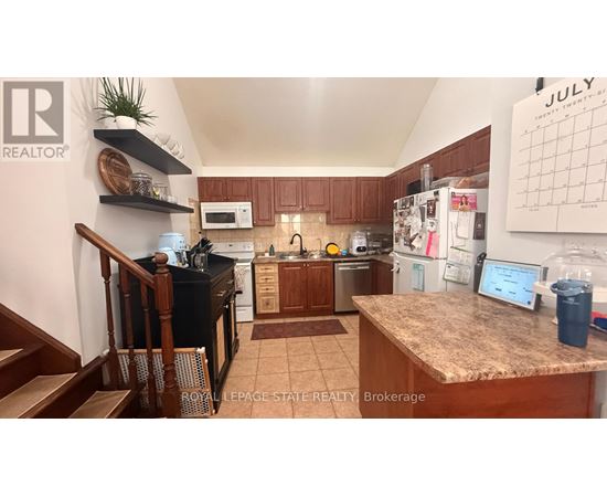 A kitchen with a counter and a calendar on the wall.