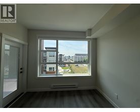 A room with a large window overlooking a cityscape.