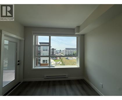 A room with a large window overlooking a cityscape.