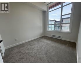 A room with a window overlooking a building.