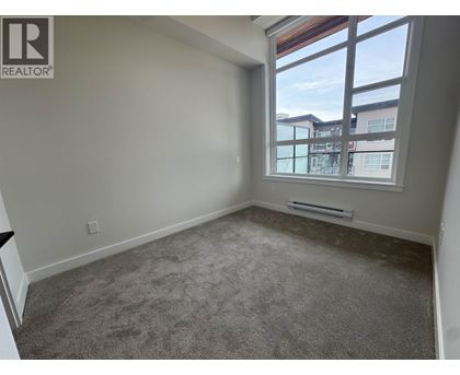 A room with a window overlooking a building.