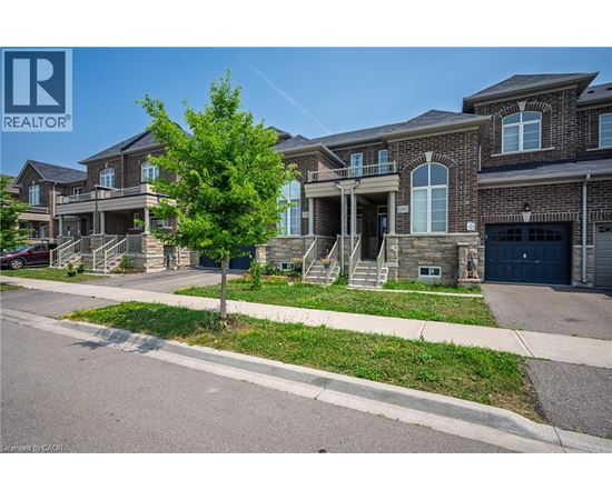 A row of houses with a REALTOR® logo in the corner.
