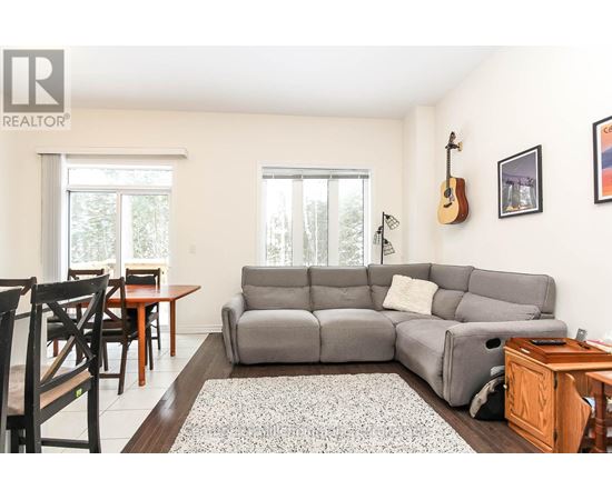 A living room with a grey couch and a wooden table.