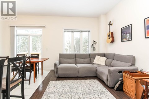 A living room with a grey couch and a wooden table.