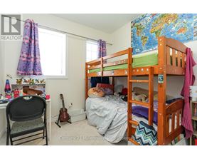 A child's bedroom with a bunk bed and a guitar.
