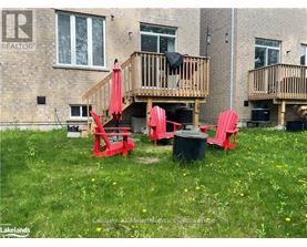 A red chair and table are set up on a lawn in front of a building.