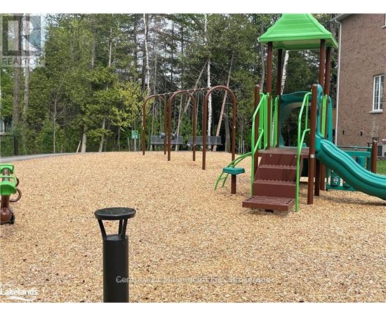 A playground with a green slide and a brown wooden structure.