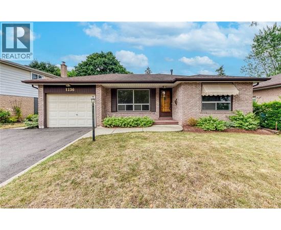 A house with a brown roof and a white garage door is for sale.