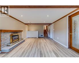A spacious living room with a fireplace and wooden flooring.
