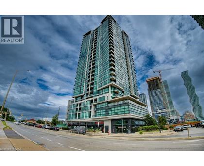 A tall building with many windows is under construction in a city.