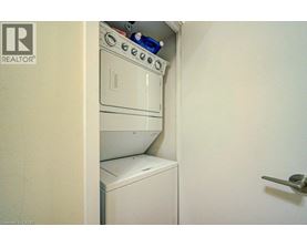 A white washing machine is in a small space.