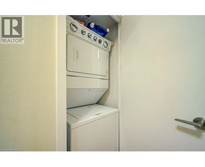 A white washing machine is in a small space.