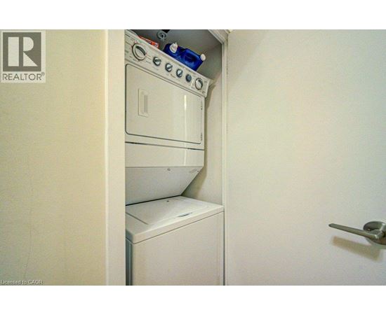 A white washing machine is in a small space.