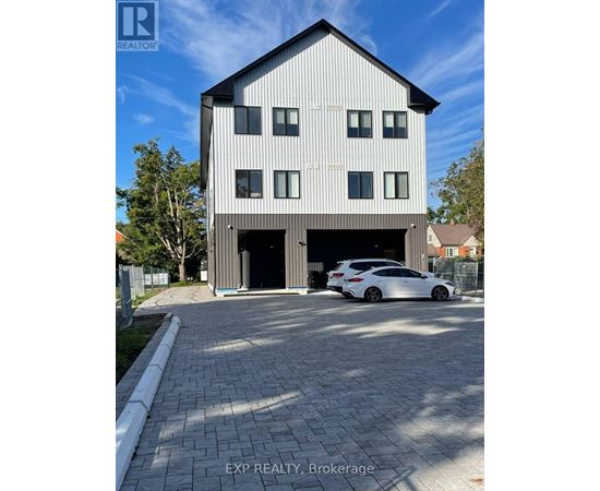 A modern house with a car parked in front.