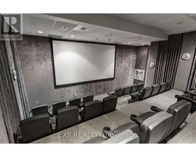A conference room with a large screen and chairs.