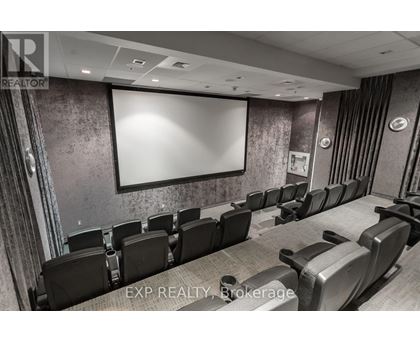 A conference room with a large screen and chairs.