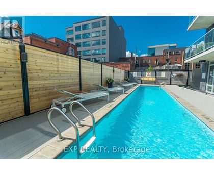 A pool surrounded by a wooden fence and a metal railing.