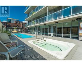A pool and hot tub area on a balcony of a building.