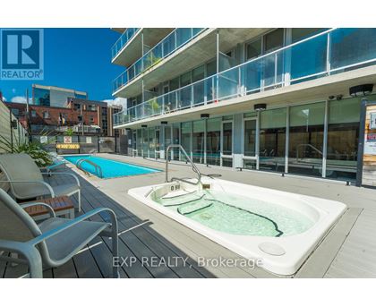 A pool and hot tub area on a balcony of a building.