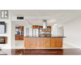 A modern kitchen with wooden cabinets and a central island.