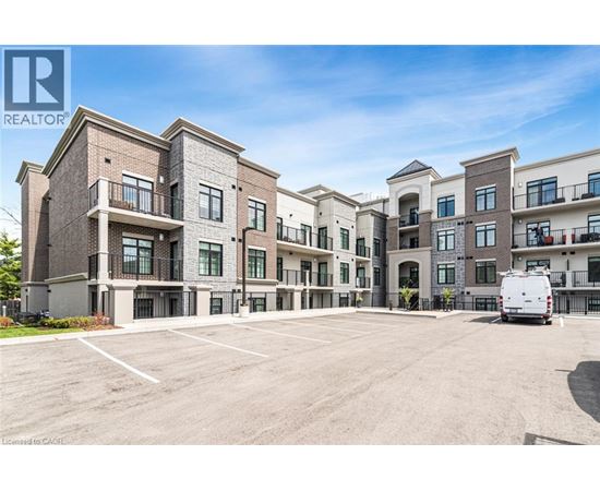 A large, multi-story apartment complex with a parking lot in front.