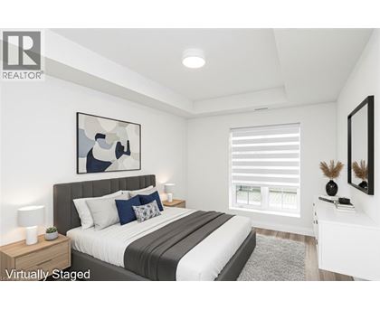 A bedroom with a large bed and a painting on the wall.