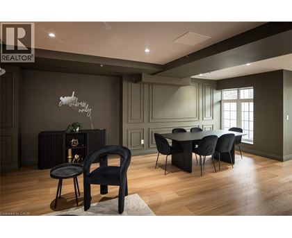 A modern dining room with a black chair and table.