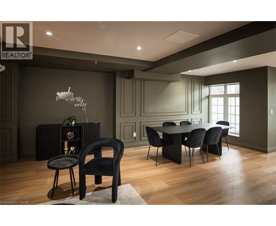 A modern dining room with a black chair and table.