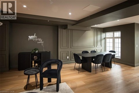A modern dining room with a black chair and table.