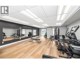 A gym with a variety of equipment including treadmills, weights, and exercise machines.